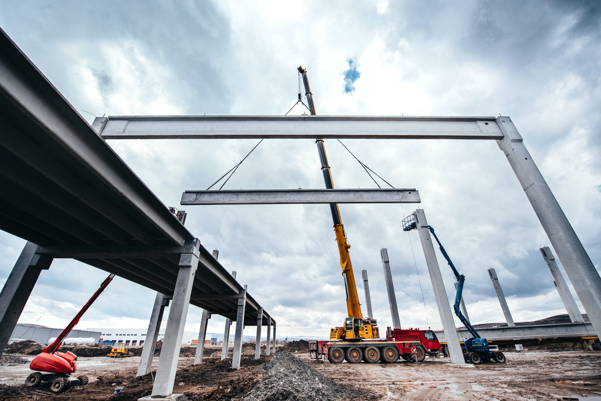 Industrial construction site with tower cranes working with prefabricated elements